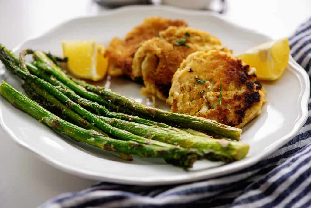 air fryer asparagus and keto crab cakes on white plate.