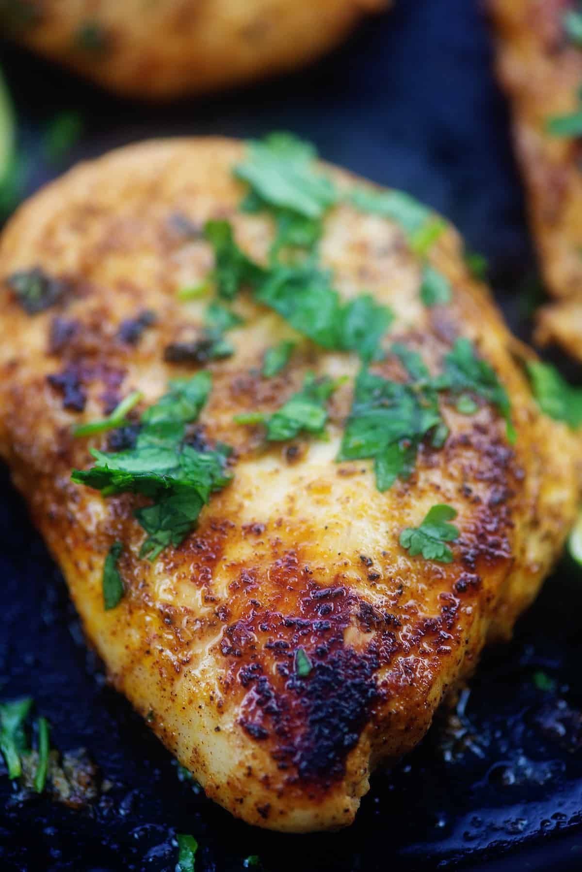 chili lime chicken breast in cast iron skillet.