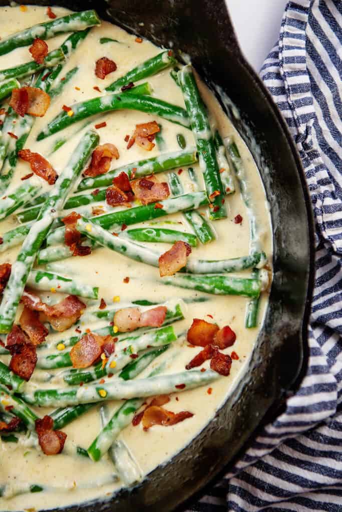 overhead view of creamy green beans in parmesan sauce.