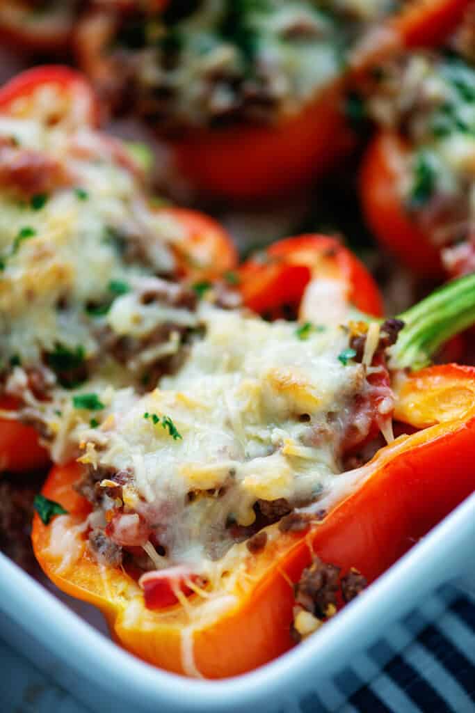 low carb Italian stuffed peppers in white baking dish.