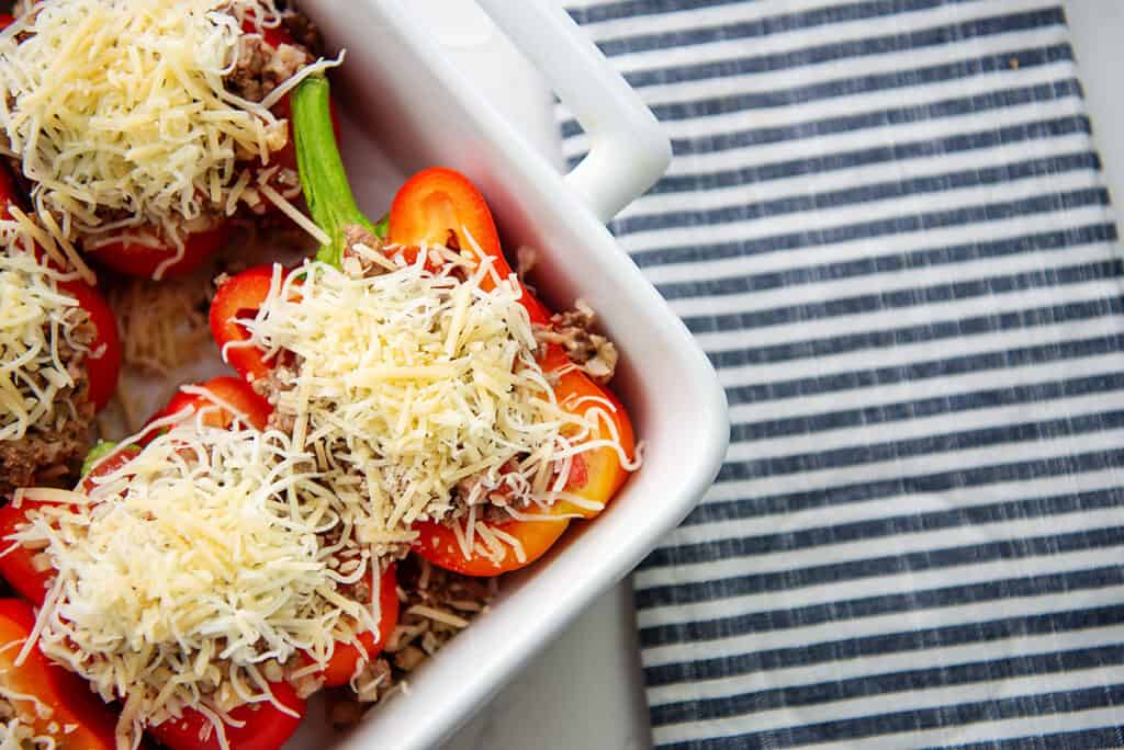 peppers stuffed with cauliflower rice and beef and topped with cheese.