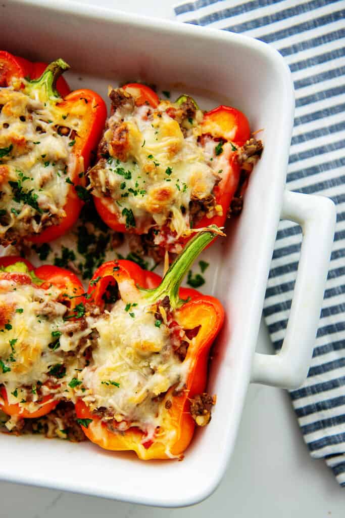 overhead view of Italian stuffed peppers in white baking dish.