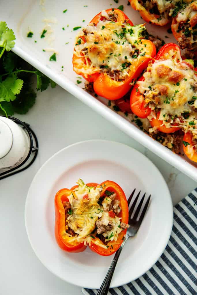 overhead view of low carb stuffed pepper on white plate.