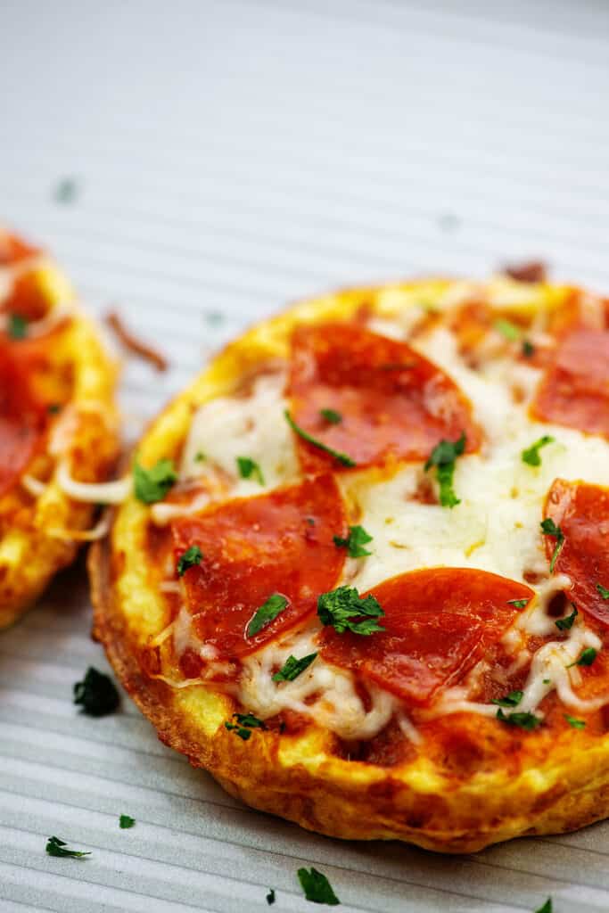 chaffle pizzas on metal baking pan.