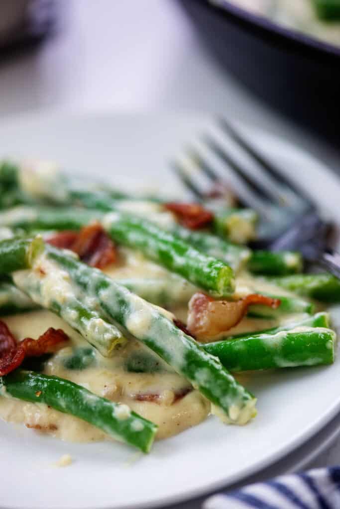 Garlic parmesan green beans on white plate.