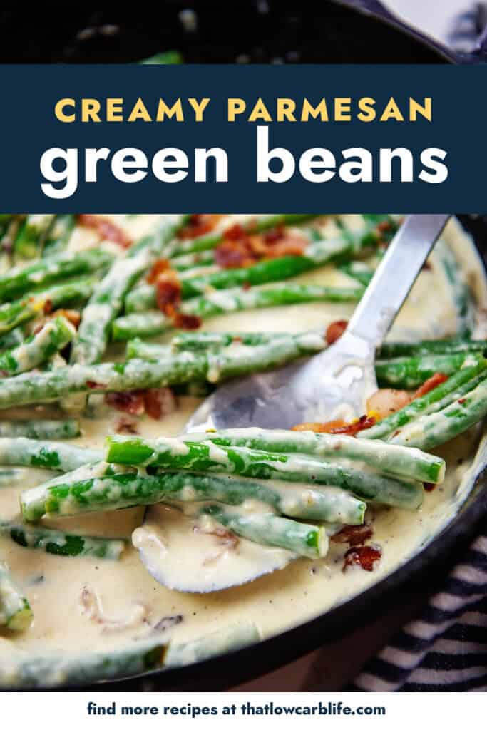 green beans in cream sauce on a spoon in a cast iron skillet.