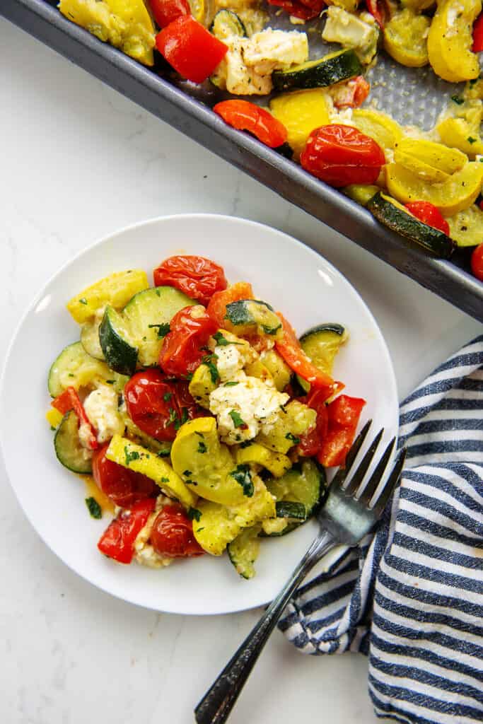 baked feta veggies on white plate.