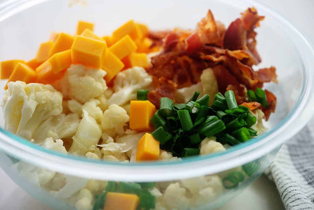 ingredients for cauliflower salad in glass bowl.