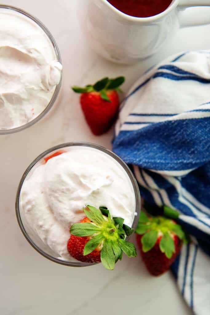 overhead view of keto strawberry whipped cream in glass containers.