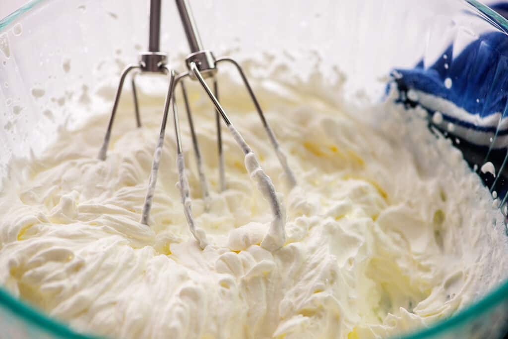 whipped cream in glass bowl.