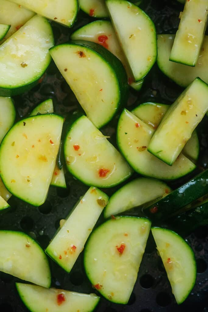 zucchini in air fryer basket.