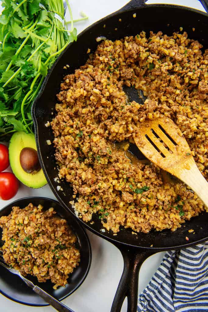 Keto cheesy cauliflower skillet with beef in cast iron skillet.