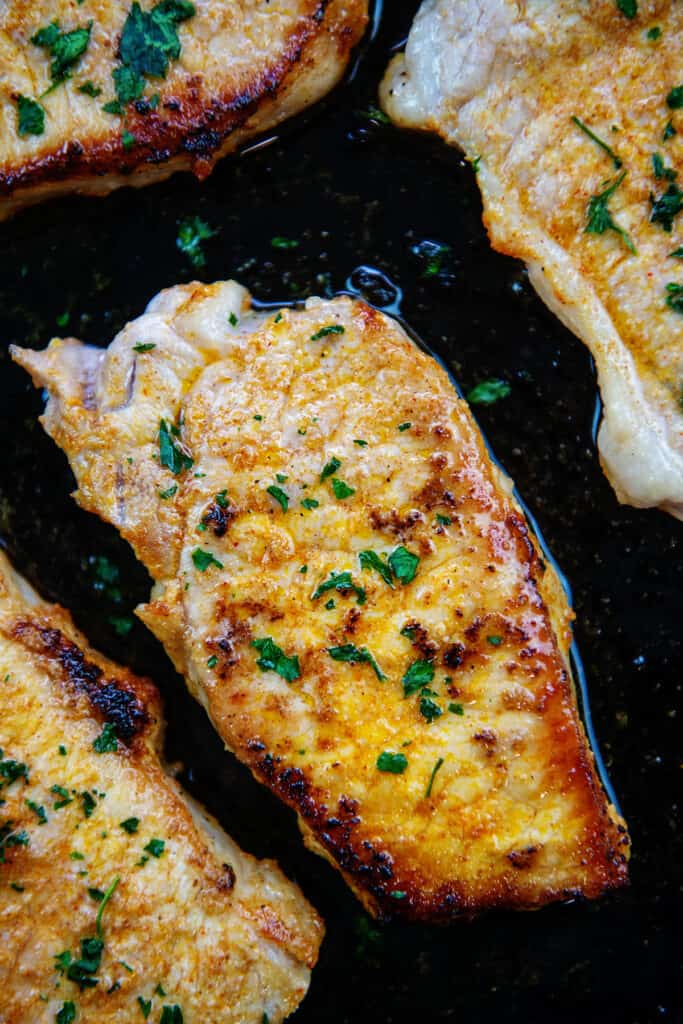 pork chops in cast iron skillet.