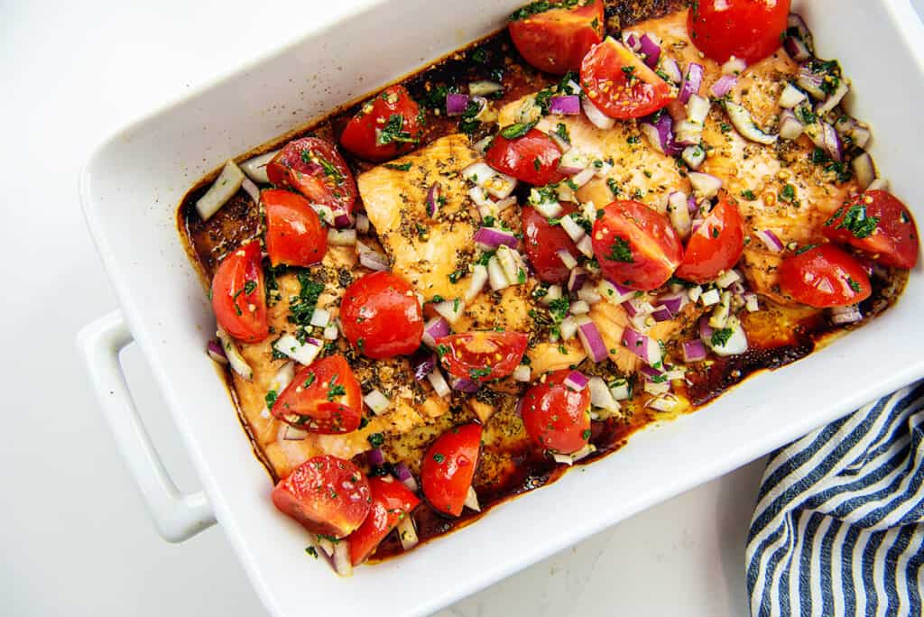 baked salmon topped with tomato bruschetta mixture.