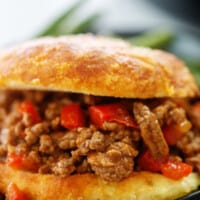 sloppy joe on keto bun on black plate.