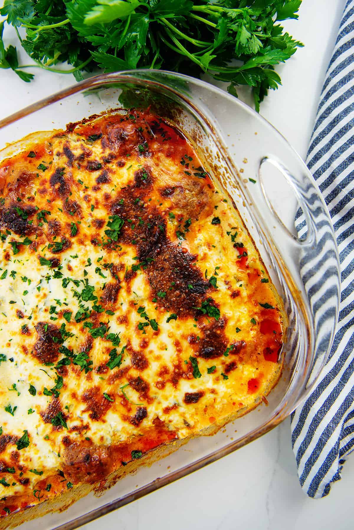 overhead view of low carb meatball casserole in glass baking dish.