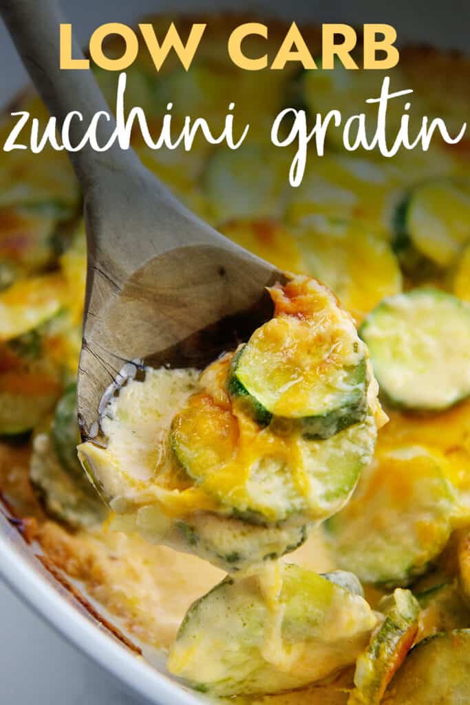 cheesy zucchini gratin on wooden spoon with text for Pinterest.