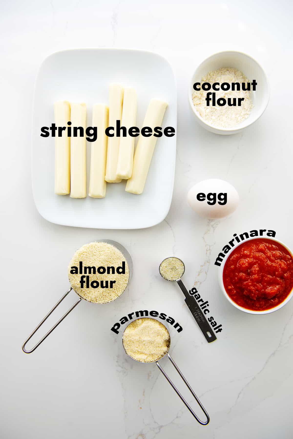 ingredients for mozzarella sticks on white counter.