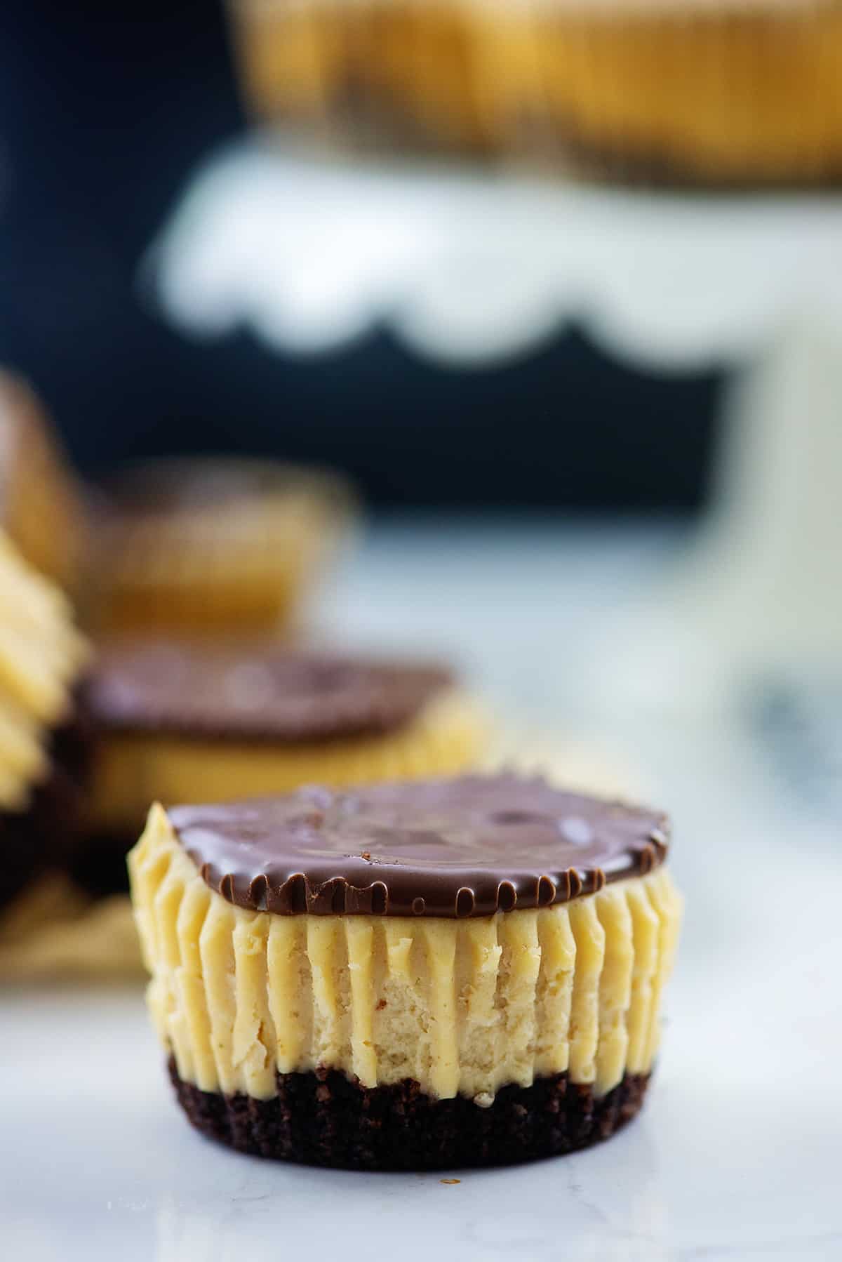 mini peanut butter cheesecake on white counter.