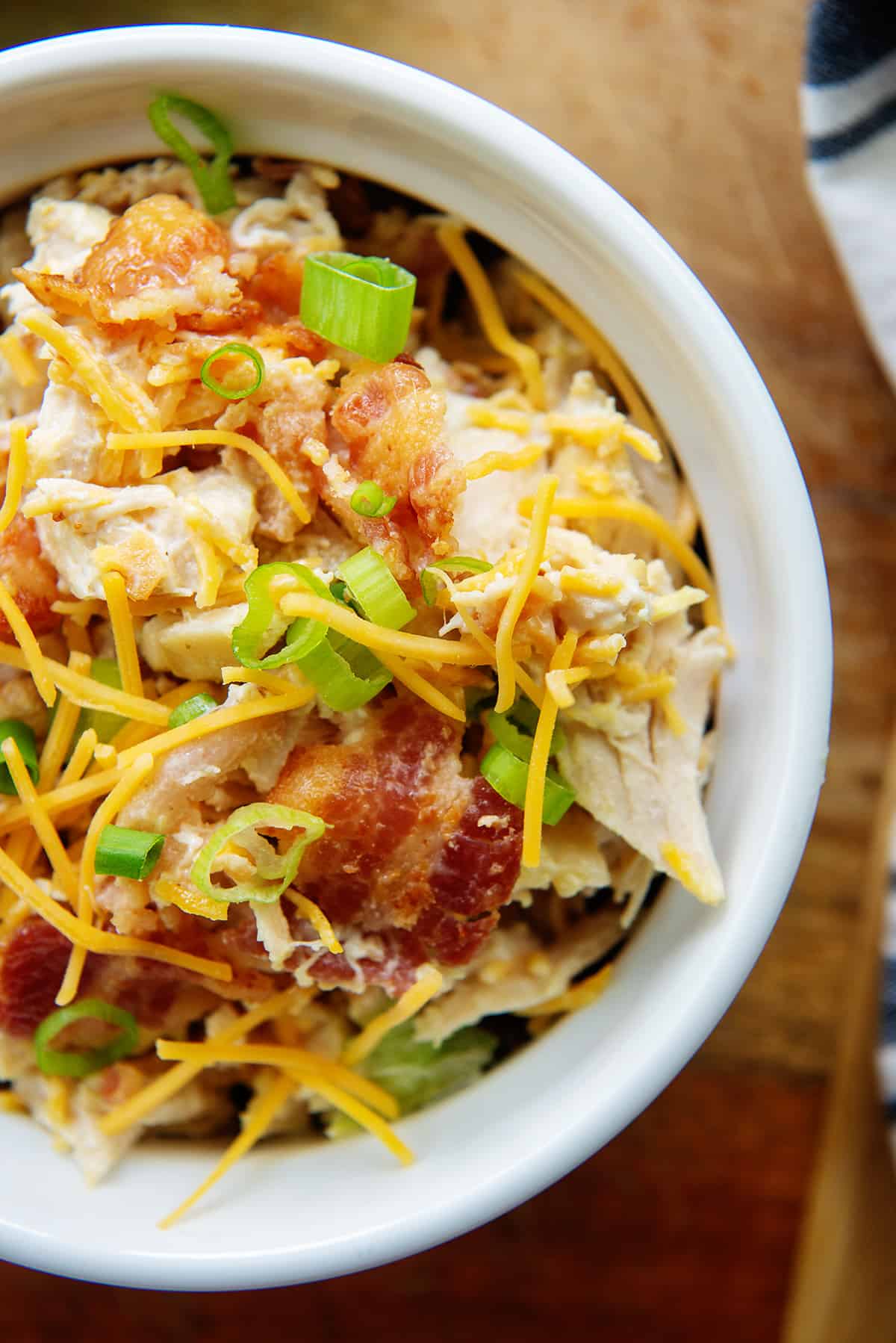 overhead view of chicken salad in white bowl.