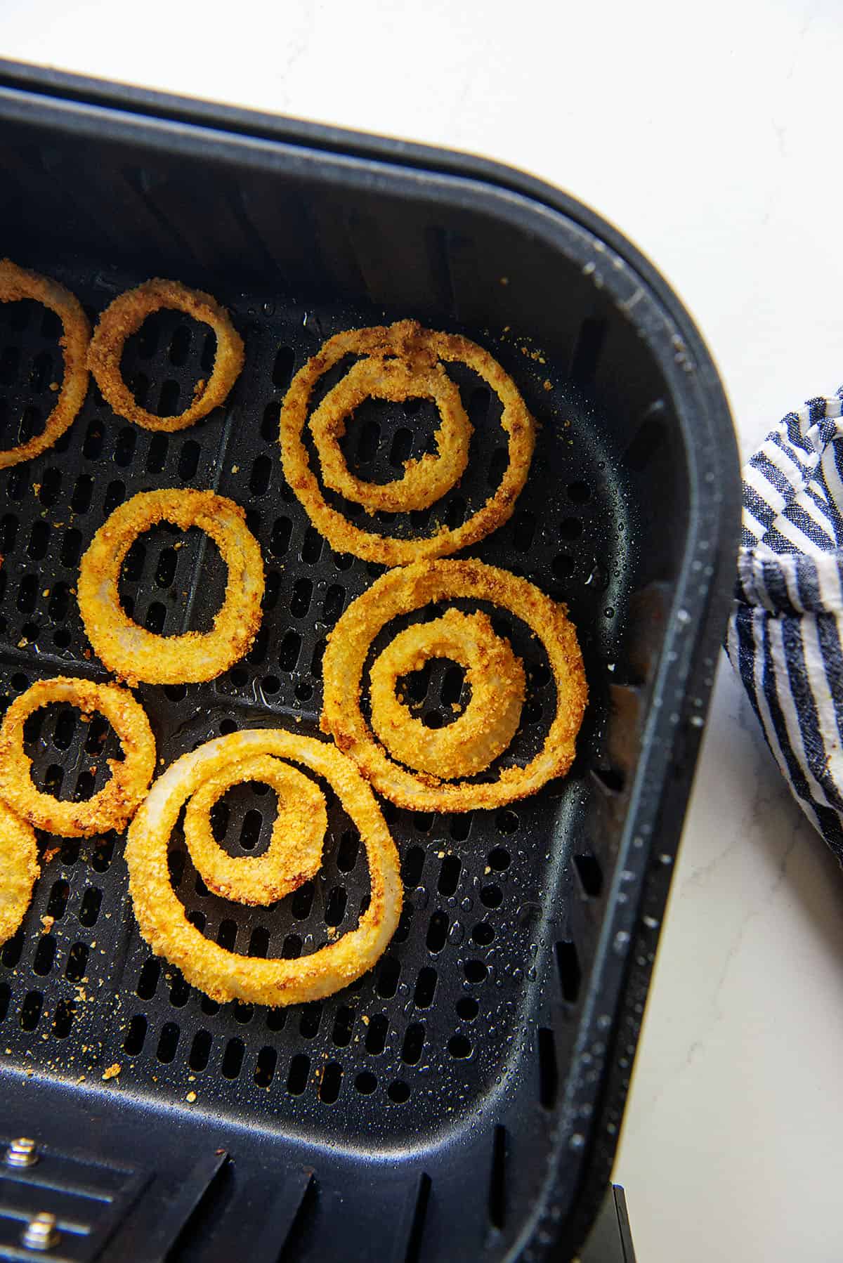 keto onion rings in air fryer basket.