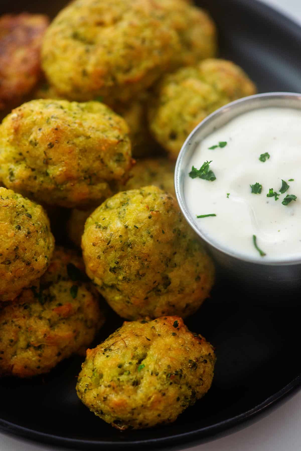 cheesy broccoli tots piled next to ranch dressing.