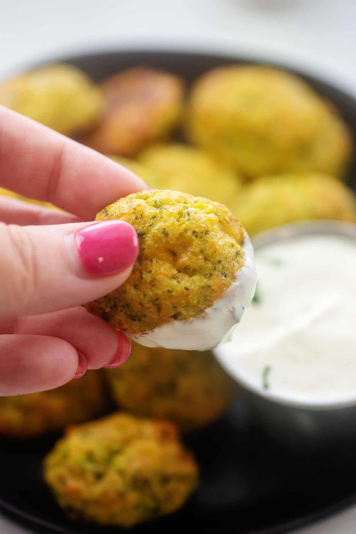 broccoli tot being dipped in ranch dressing.