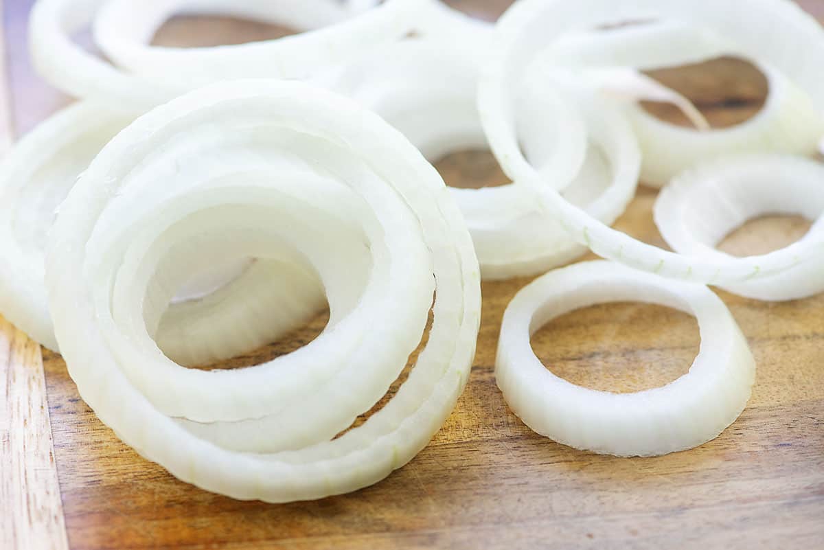 sliced onion on cutting board.