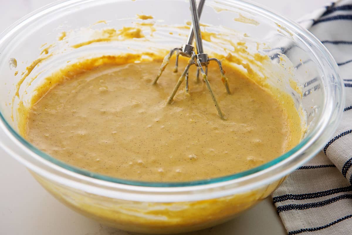 cheesecake batter in glass mixing bowl.