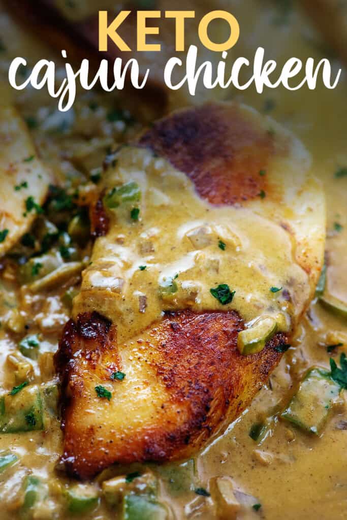 Creamy Cajun chicken in skillet with text for Pinterest.