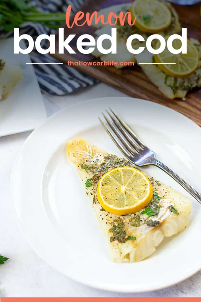 cod on white plate with lemon on top.