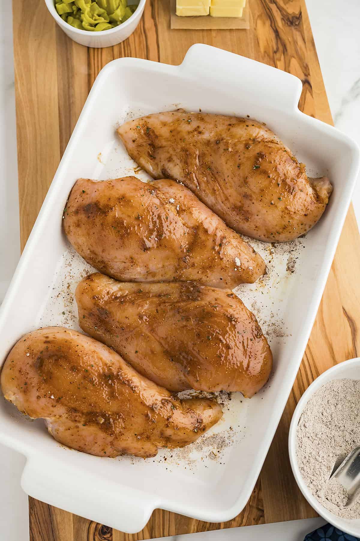 Seasoned chicken in baking dish.