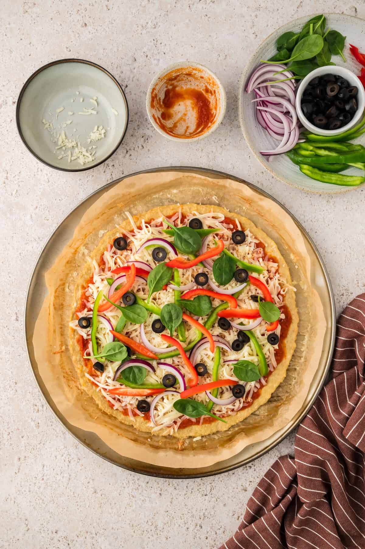Chciken crust pizza with topping about to go in the oven.
