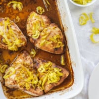 baked Mississippi chicken in a white baking dish.
