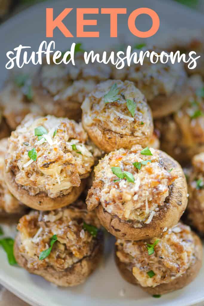 sausage stuffed mushrooms on plate with text for Pinterest.