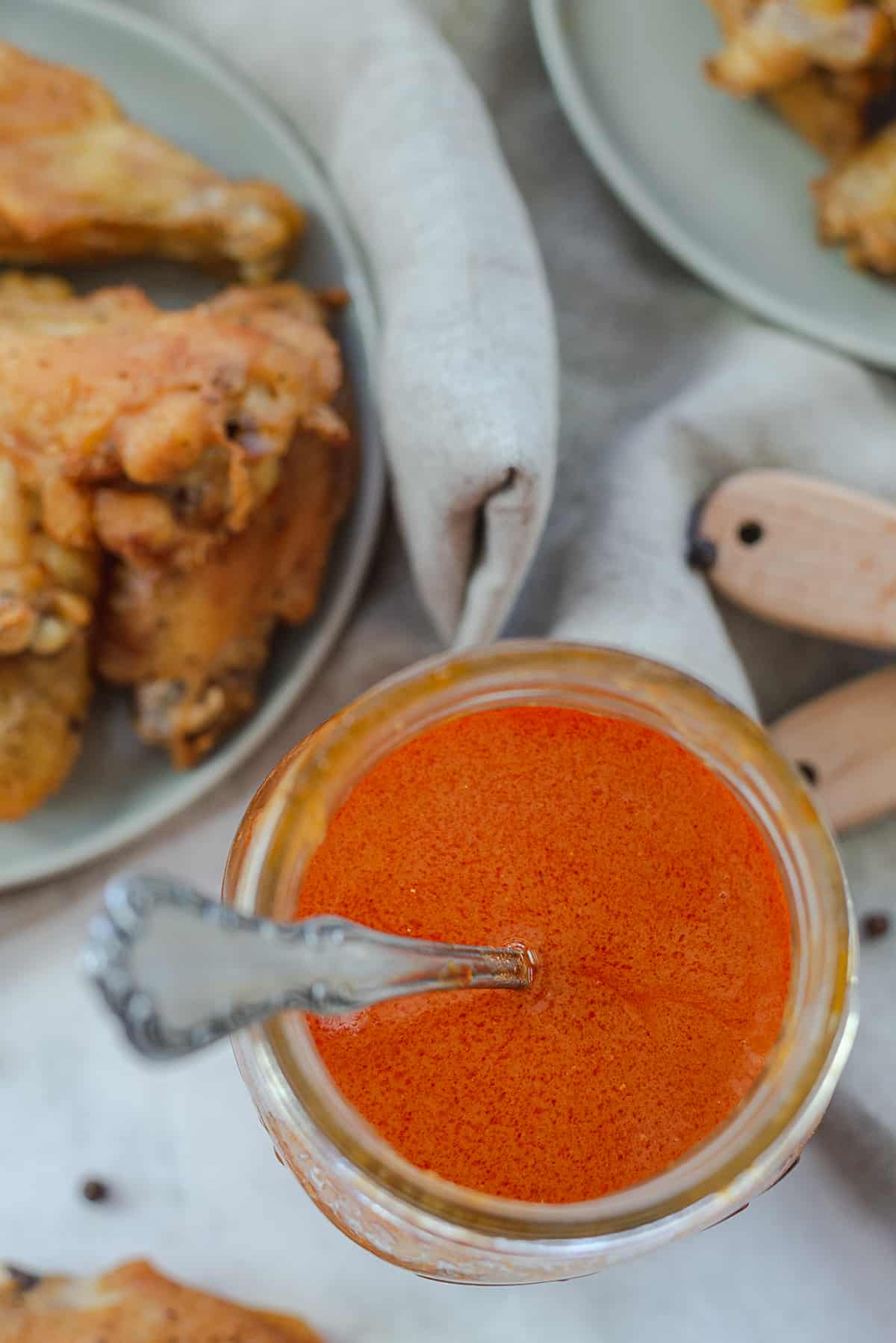 overhead view of buffalo wing sauce in mason jar.