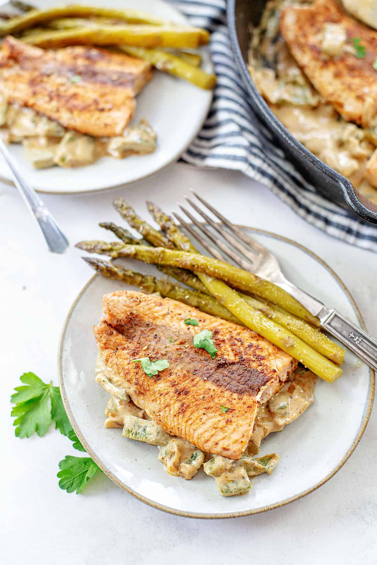 salmon filets on white plates.