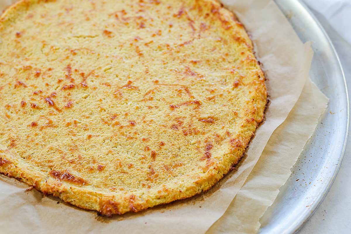 cauliflower pizza crust on pizza pan.