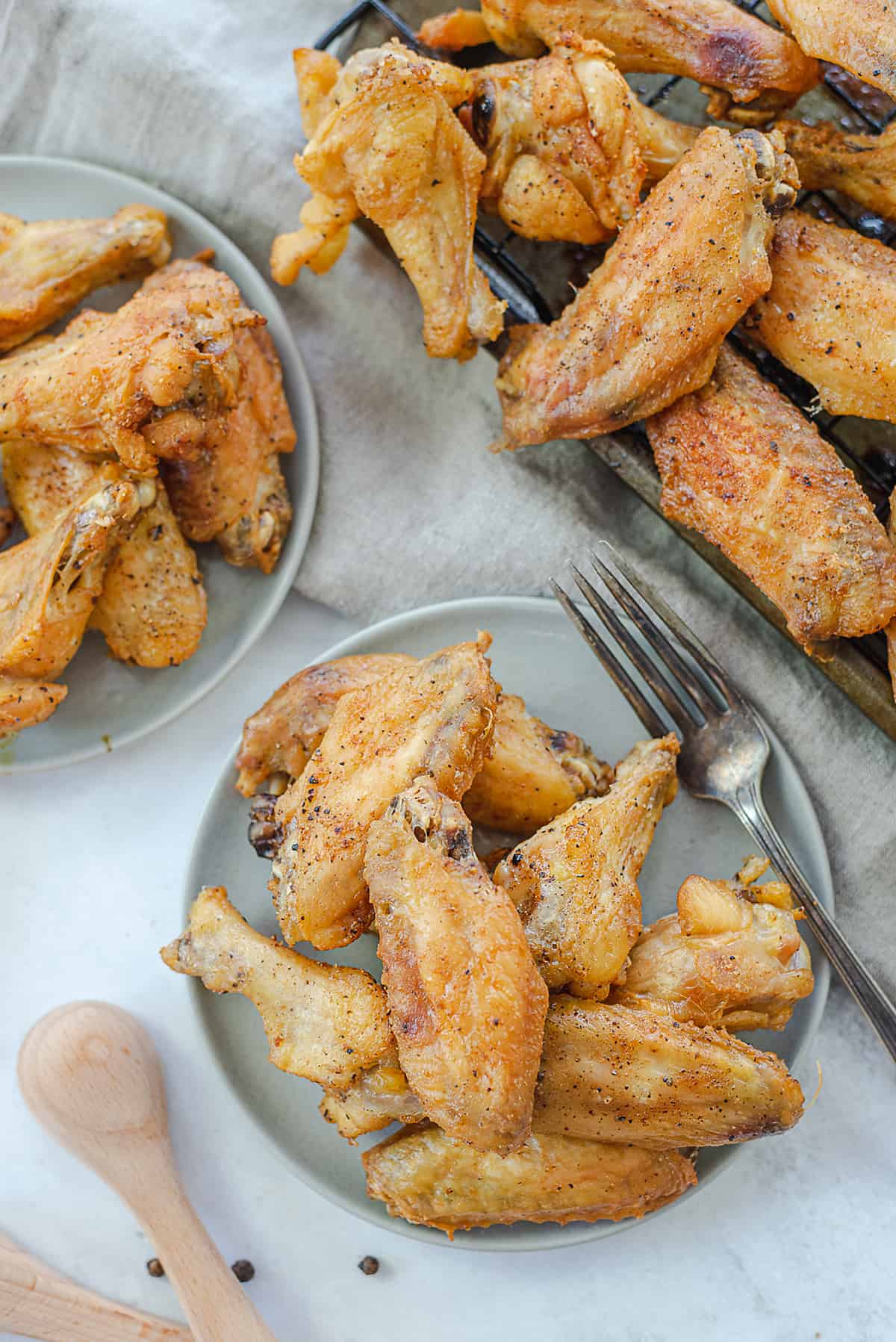 crispy baked chicken wings on plates.