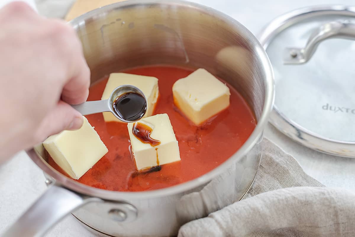 adding ingredients to sauce pan.
