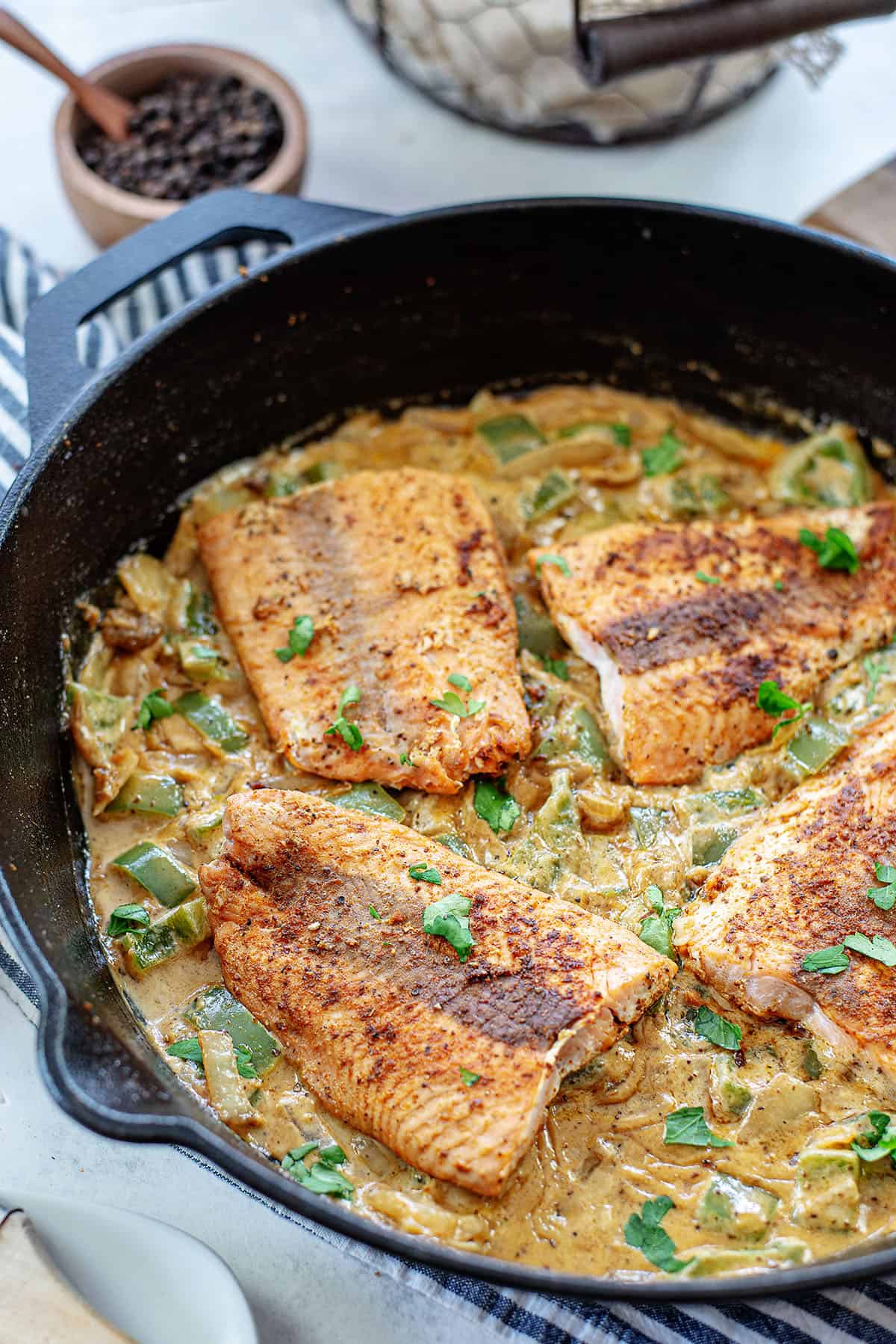 creamy Cajun salmon in cast iron skillet.