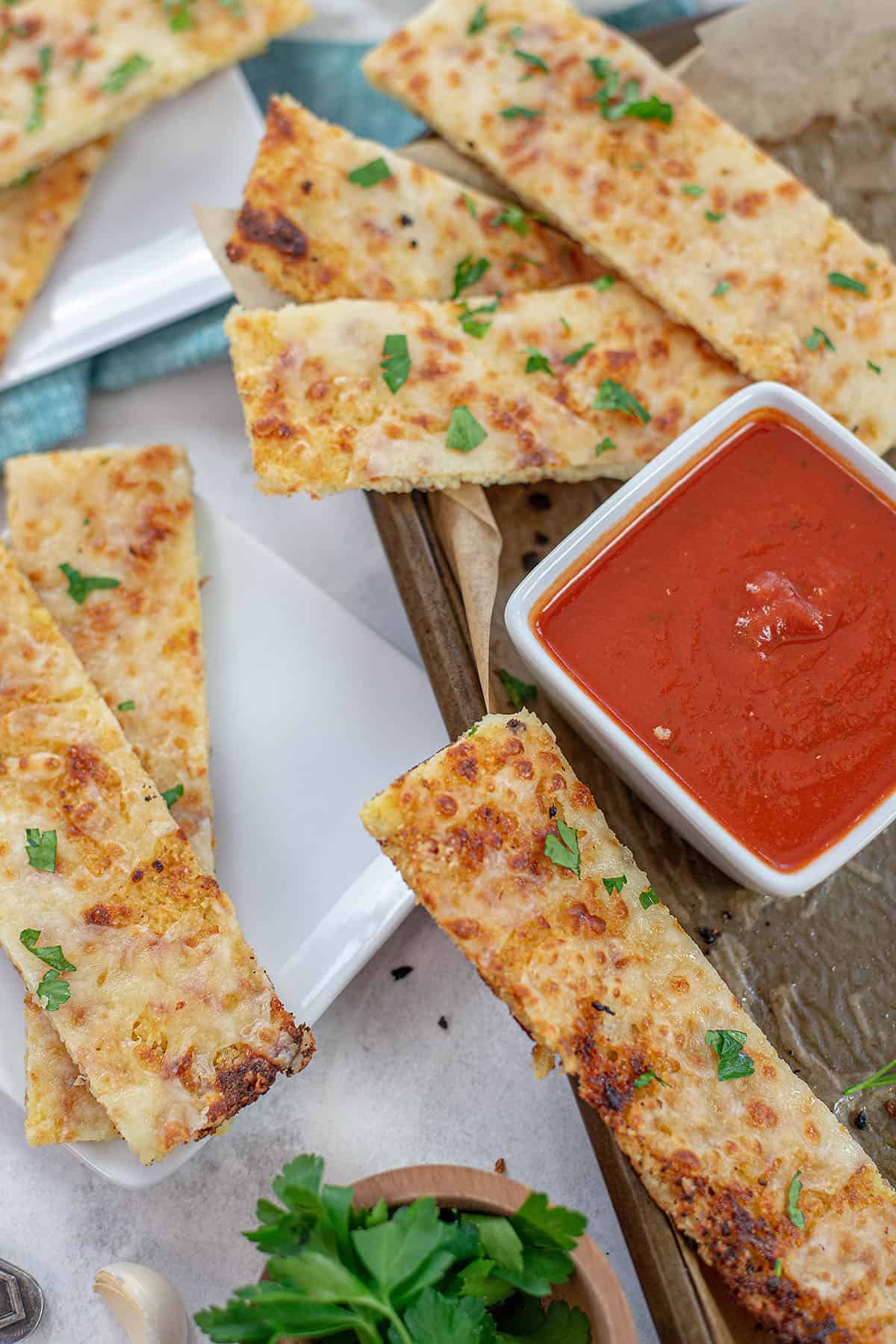 keto cauliflower breadsticks with bowl of marinara.