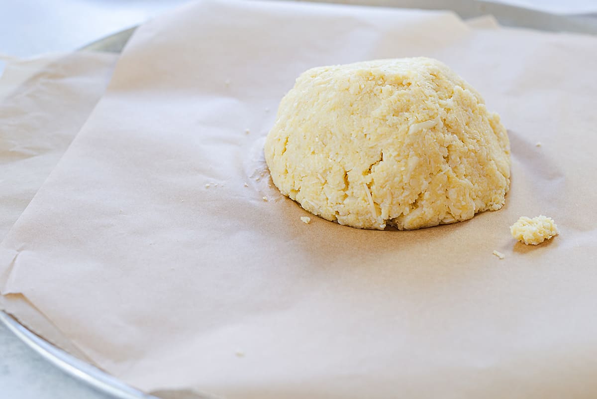 cauliflower pizza dough on baking sheet.