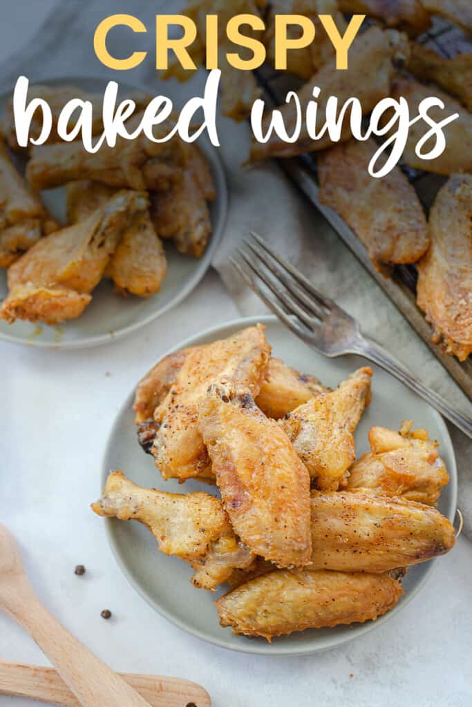 baked chicken wings on plate with text for Pinterest.