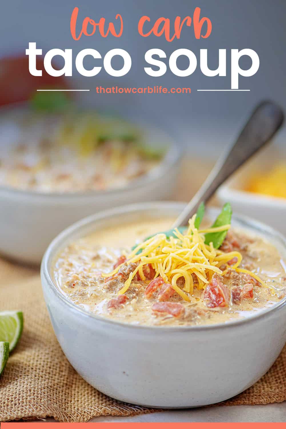 keto taco soup in white bowl topped with cheese.