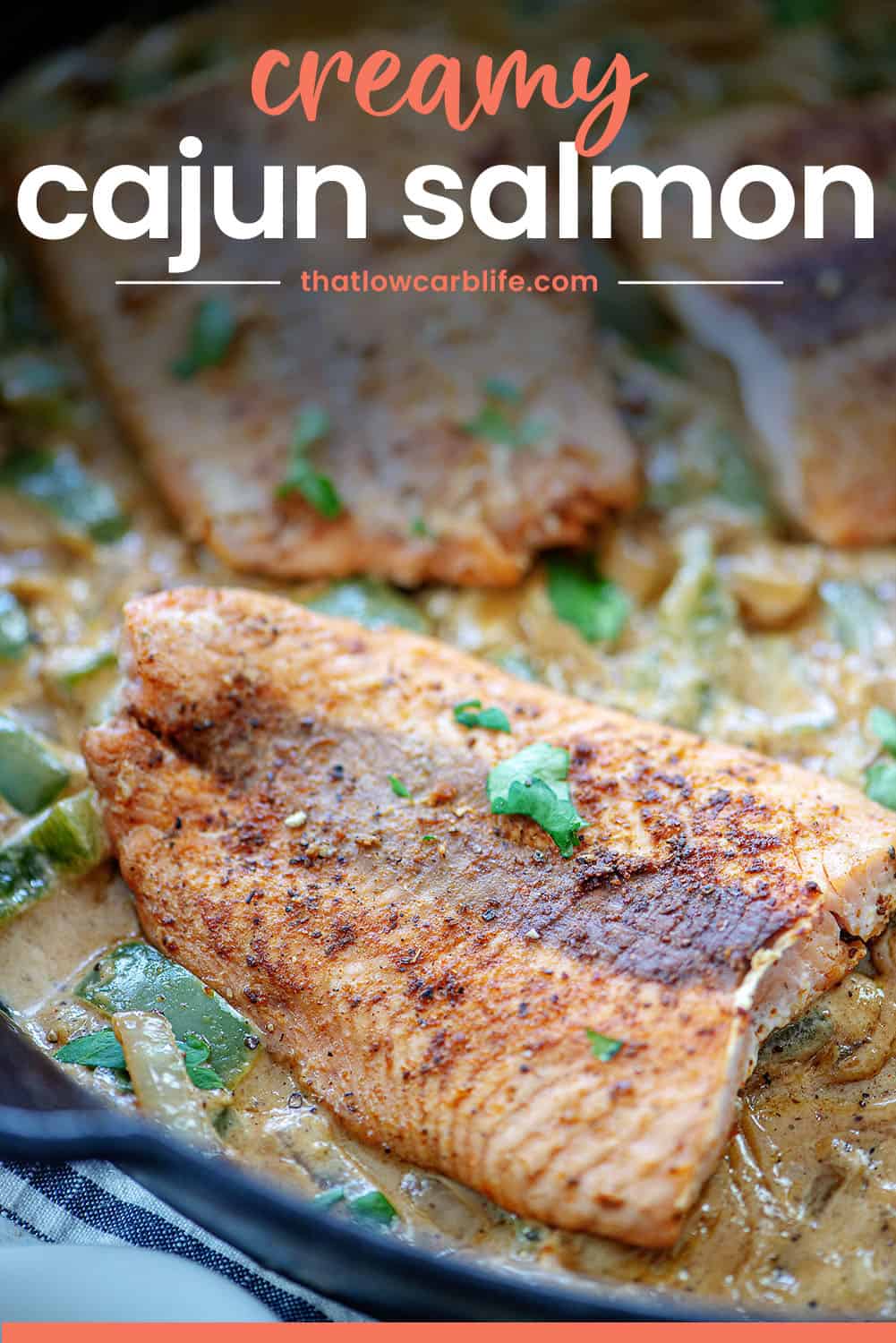 creamy cajun salmon in skillet.