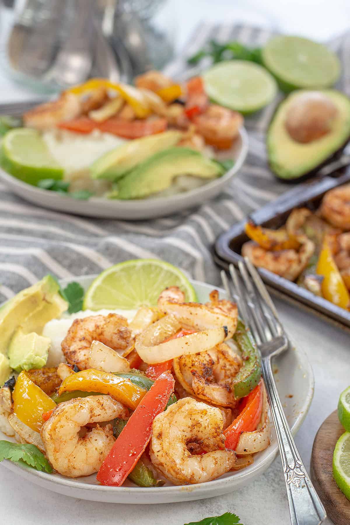 shrimp fajitas on plate with cauliflower rice.