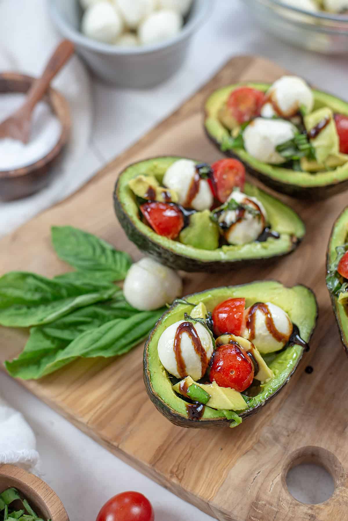 keto caprese avocado on wooden board.