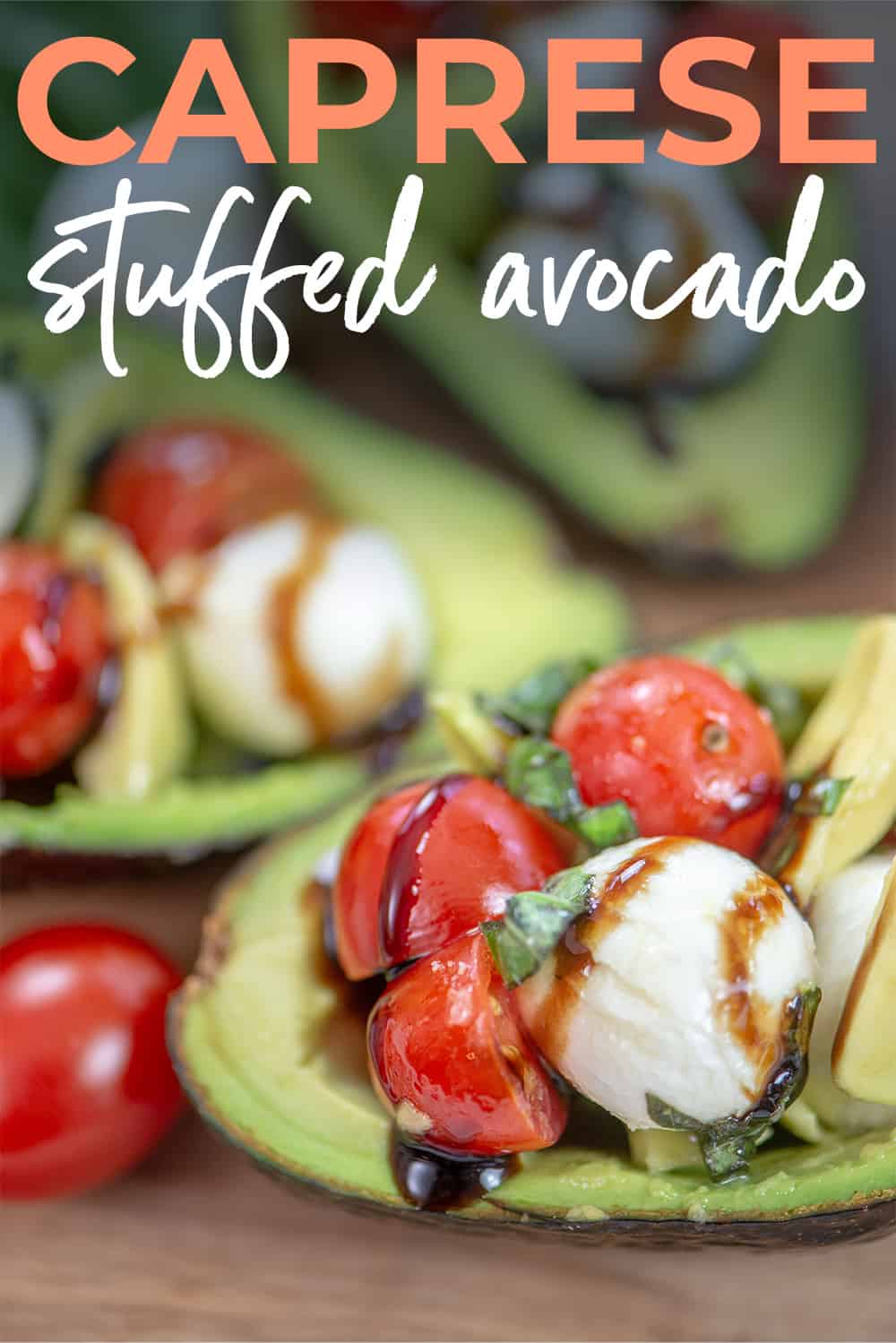 caprese stuffed avocado on board with text for pinterest.