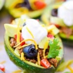 Avocado stuffed with taco meat and toppings.